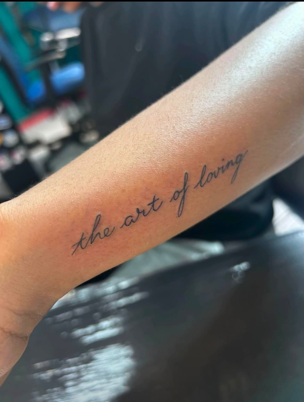 The art of loving script forearm tattoo