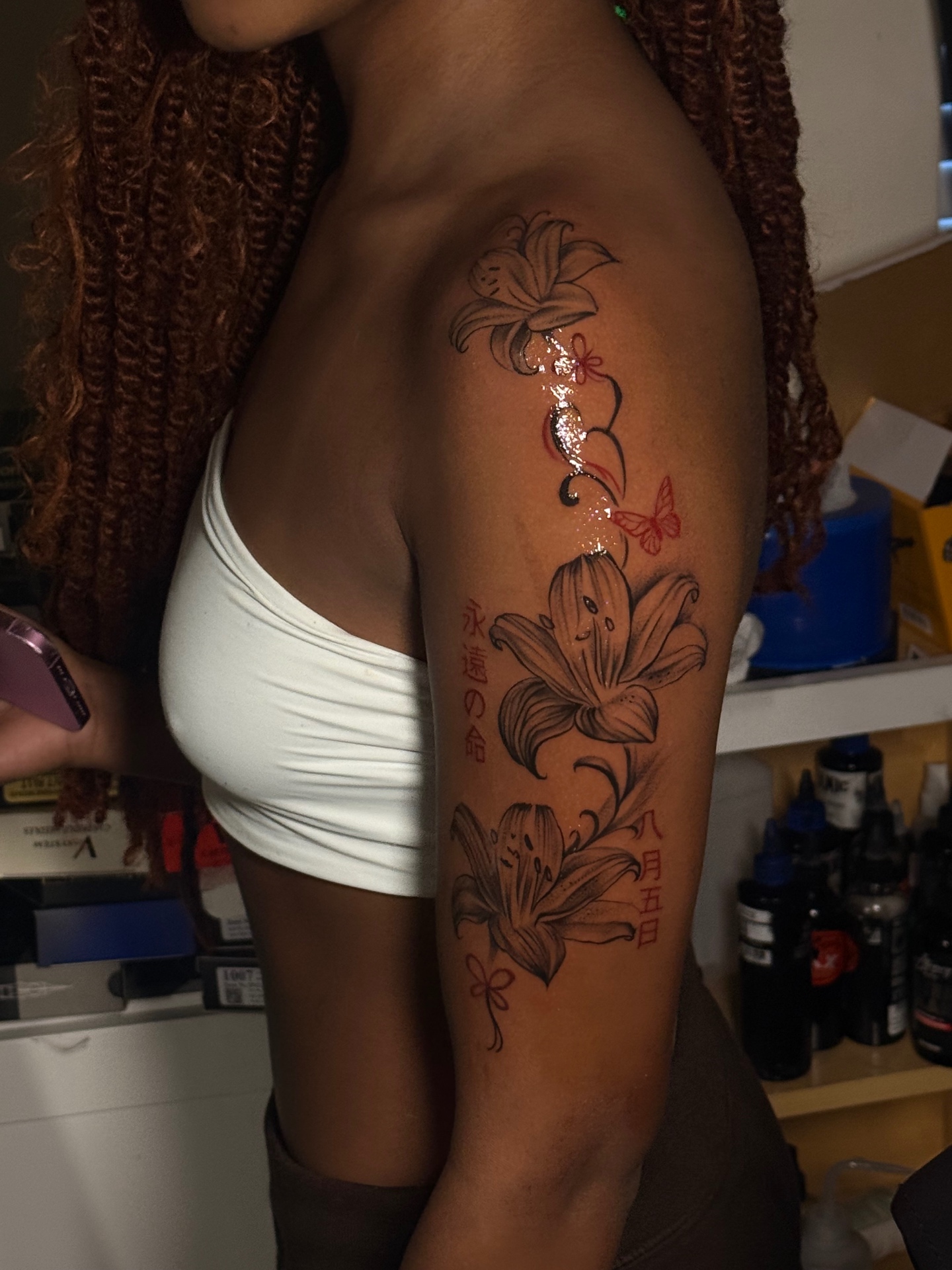 Floral shoulder tattoo with red accents