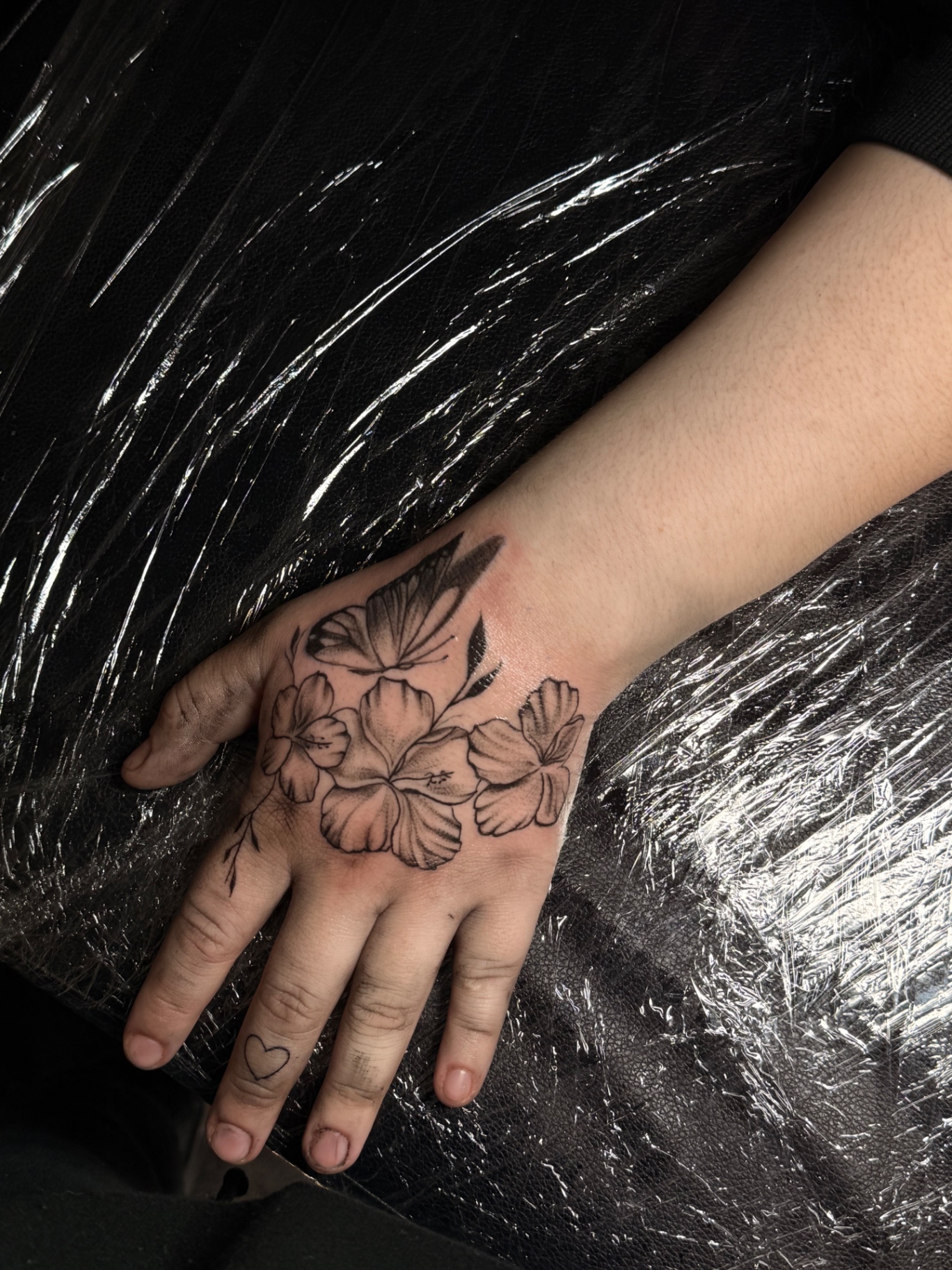 Butterfly and hibiscus flowers hand tattoo