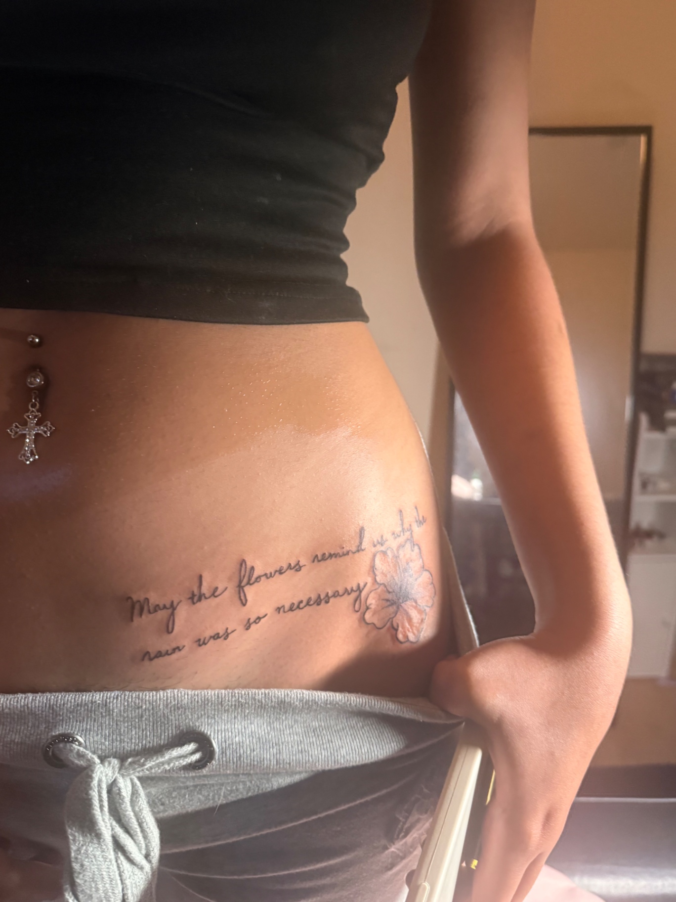 Script and hibiscus flower hip tattoo