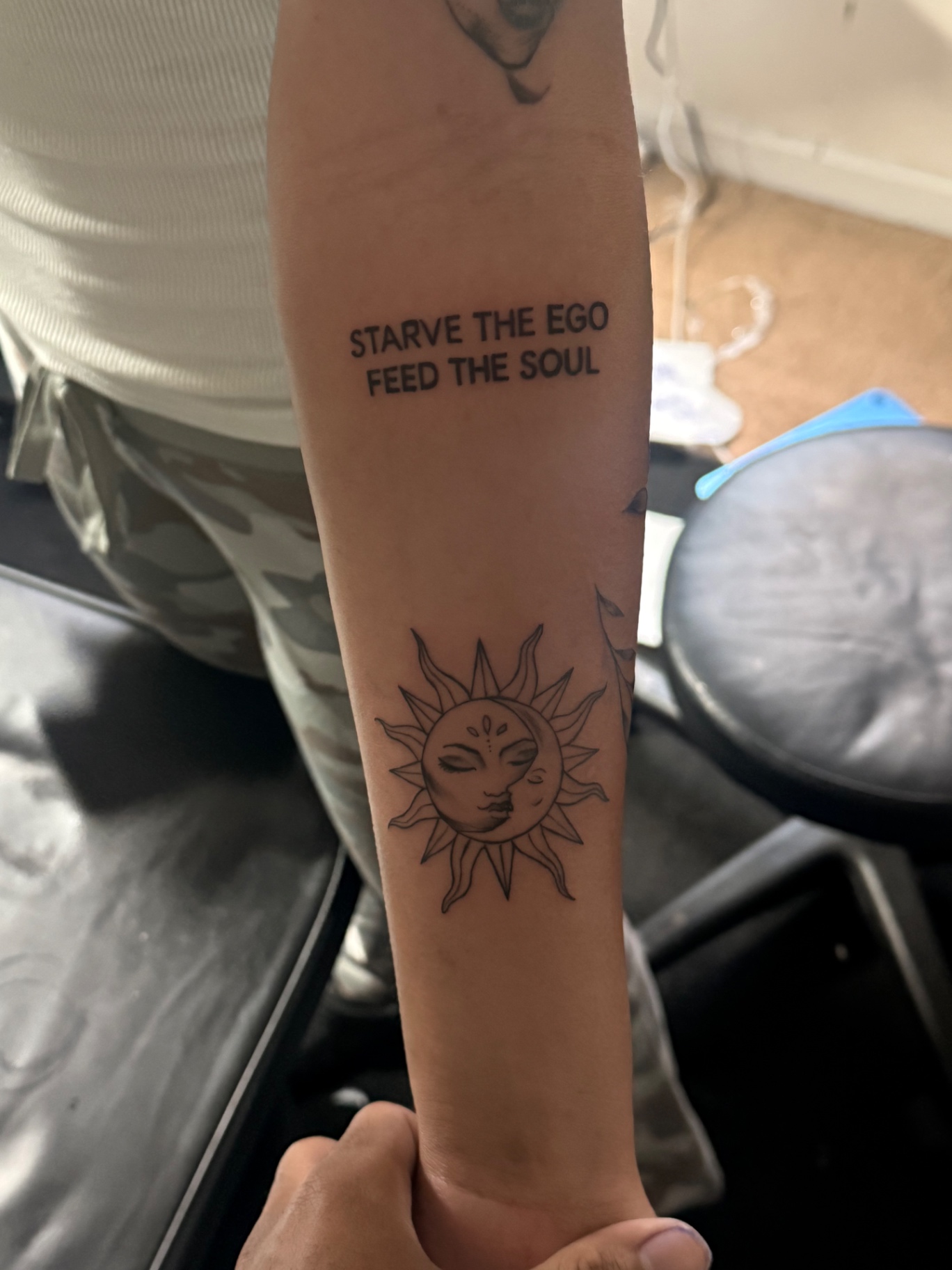 Sun and moon forearm tattoo with lettering